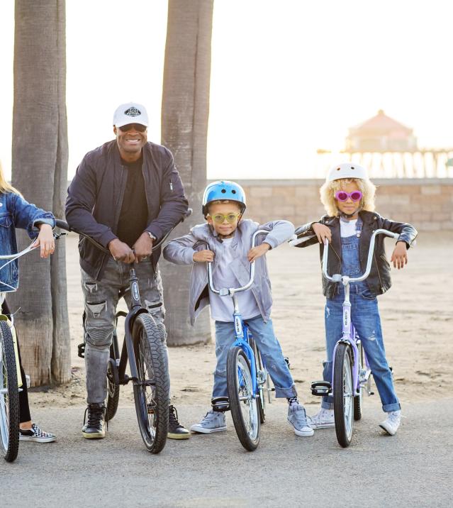 Biking in Huntington Beach | Family on a bike with the pier in the back